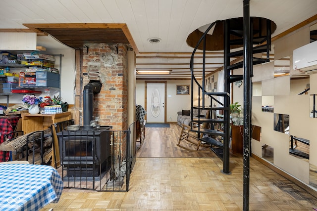 interior space with light parquet floors, a wood stove, a wall mounted AC, and wood ceiling