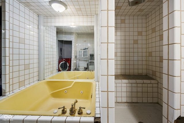 bathroom featuring tile walls and tiled tub