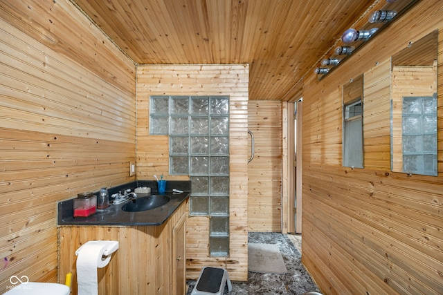 bathroom featuring sink, wood ceiling, and wood walls