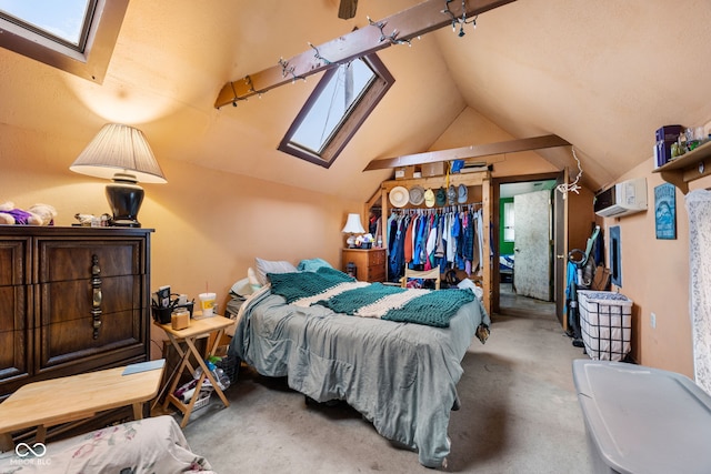 bedroom featuring vaulted ceiling with skylight and carpet