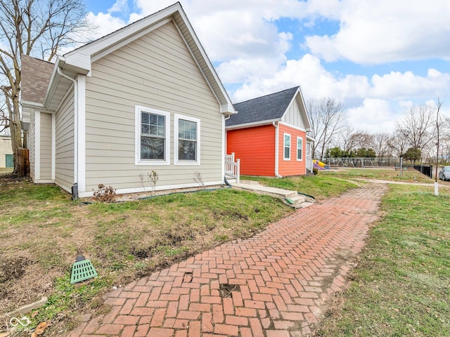 view of side of home featuring a lawn