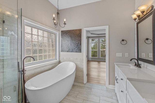 10346 Strongbow Rd, Fishers, IN 46040 - full bath featuring a chandelier, vanity, a soaking tub, a stall shower, and tile walls