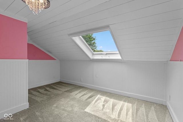 10346 Strongbow Rd, Fishers, IN 46040 - bonus room featuring a skylight, carpet floors, lofted ceiling, a chandelier, and wainscoting