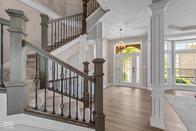 10346 Strongbow Rd, Fishers, IN 46040 - entryway with ornate columns, wood finished floors, stairway, and a chandelier