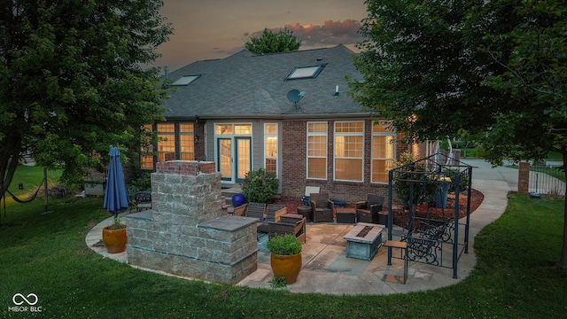 10346 Strongbow Rd, Fishers, IN 46040 - rear view of house with a patio, a lawn, an outdoor living space with a fire pit, roof with shingles, and brick siding