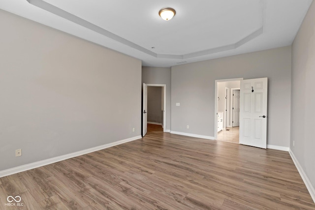 10346 Strongbow Rd, Fishers, IN 46040 - unfurnished bedroom with a tray ceiling and wood finished floors