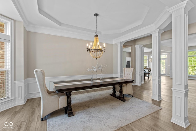 10346 Strongbow Rd, Fishers, IN 46040 - dining room with wood finished floors, a chandelier, a raised ceiling, ornate columns, and crown molding