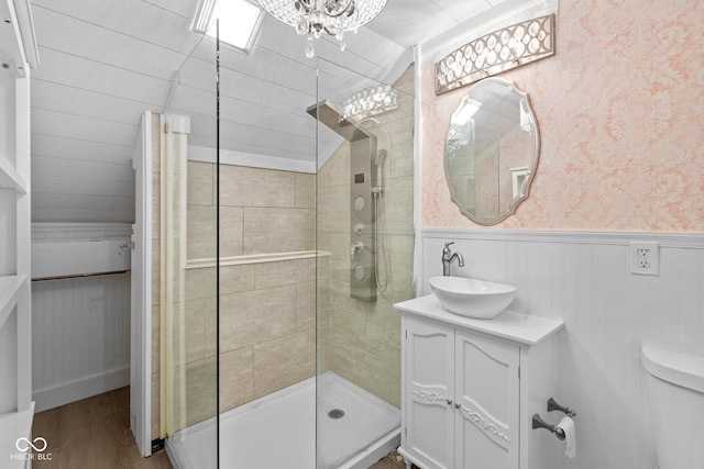 10346 Strongbow Rd, Fishers, IN 46040 - full bath featuring tiled shower, vanity, wood finished floors, vaulted ceiling, and wainscoting