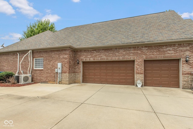 10346 Strongbow Rd, Fishers, IN 46040 - view of front facade featuring a shingled roof, concrete driveway, brick siding, and a garage