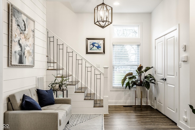 entryway featuring dark hardwood / wood-style floors and an inviting chandelier