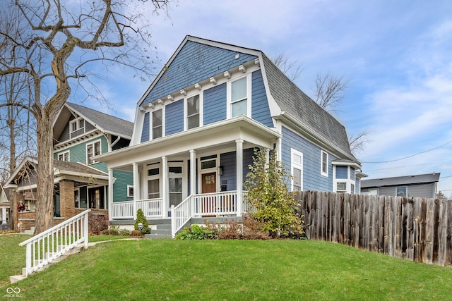 view of front facade with covered porch and a front yard