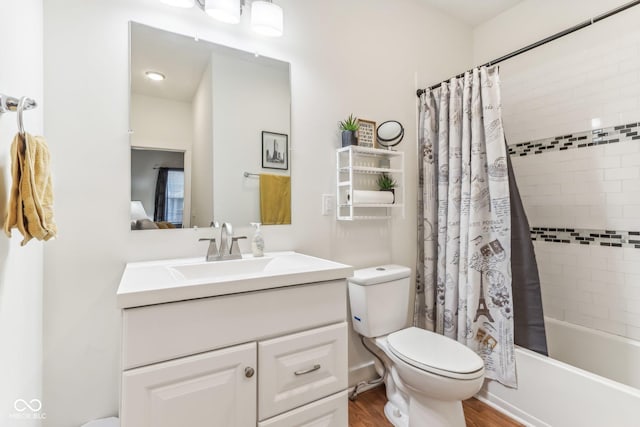 full bathroom with hardwood / wood-style floors, vanity, toilet, and shower / bath combo with shower curtain