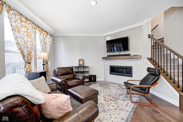 living room with hardwood / wood-style flooring and ornamental molding