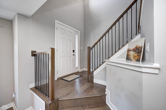 foyer featuring a textured ceiling and hardwood / wood-style flooring