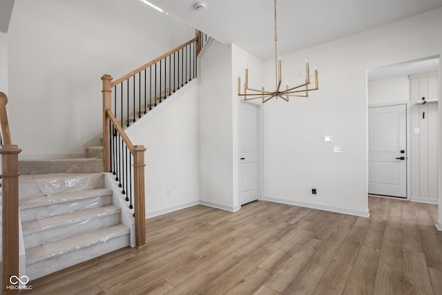 interior space with an inviting chandelier and light hardwood / wood-style flooring