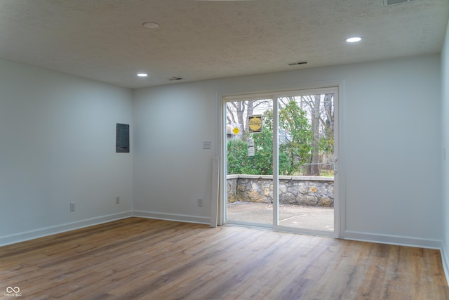 unfurnished room with hardwood / wood-style floors