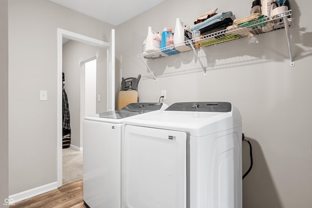 clothes washing area featuring independent washer and dryer and light wood-type flooring