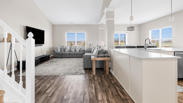 kitchen featuring a wealth of natural light, sink, dark wood-type flooring, and decorative light fixtures