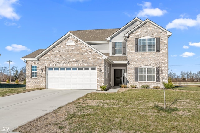 view of front of home with a front yard and a garage