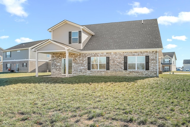 rear view of property with a yard