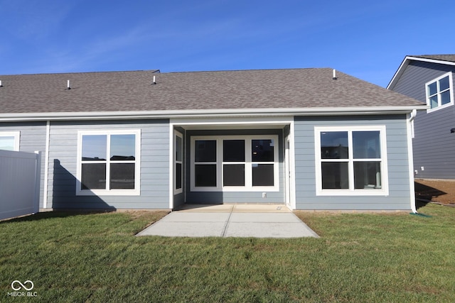 back of property featuring a patio area and a yard