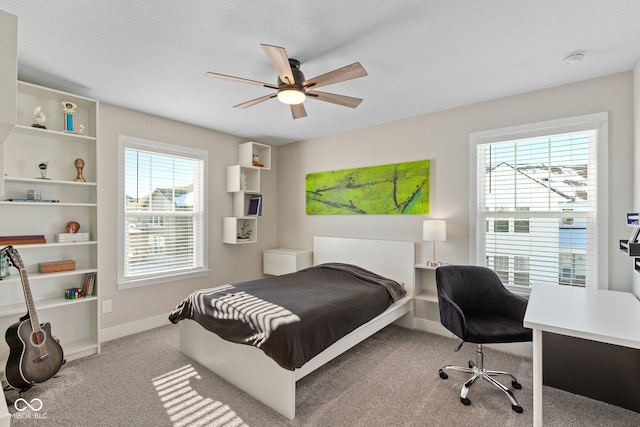 bedroom featuring ceiling fan and light carpet