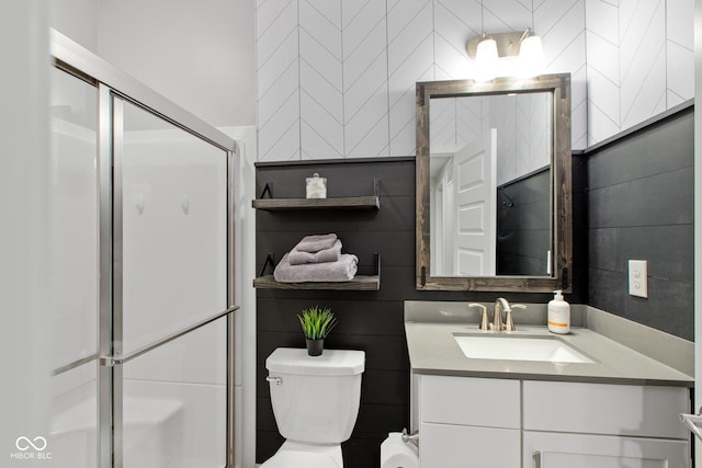 bathroom with an enclosed shower, vanity, and toilet