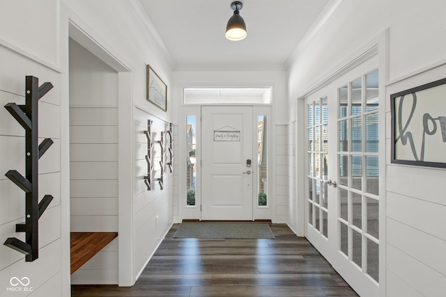 entrance foyer featuring ornamental molding and dark hardwood / wood-style floors