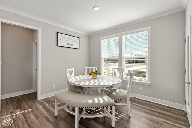 dining area featuring crown molding and dark wood-type flooring