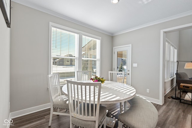 dining room featuring ornamental molding and dark hardwood / wood-style floors