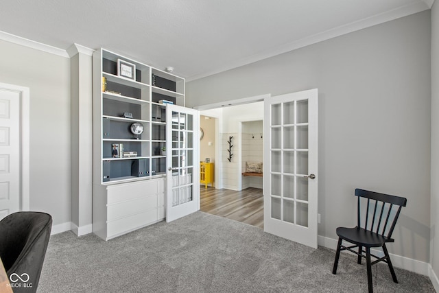 sitting room featuring ornamental molding, french doors, and carpet