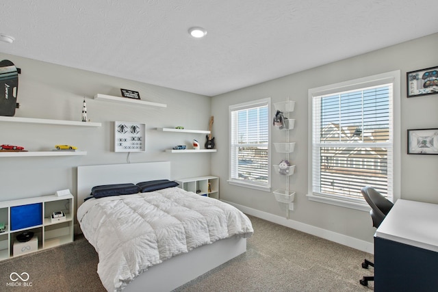 carpeted bedroom with a textured ceiling