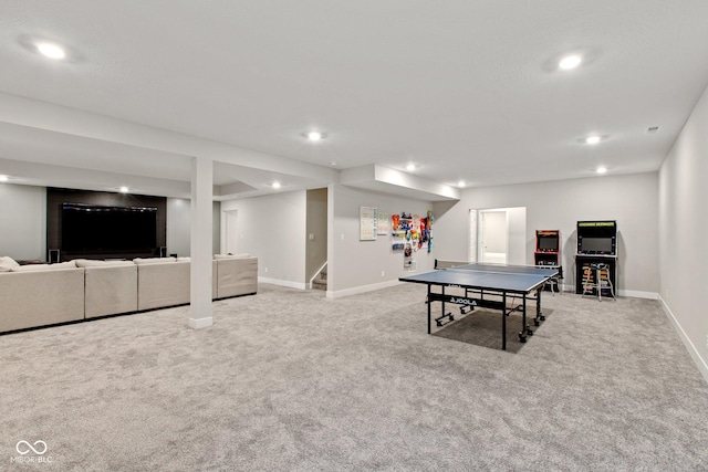 recreation room with light colored carpet