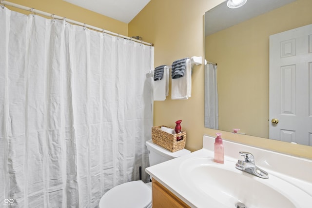 bathroom featuring toilet and vanity