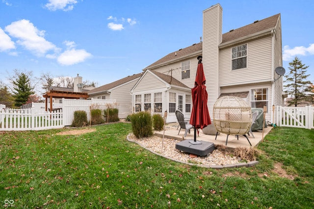 back of property with a patio area and a yard