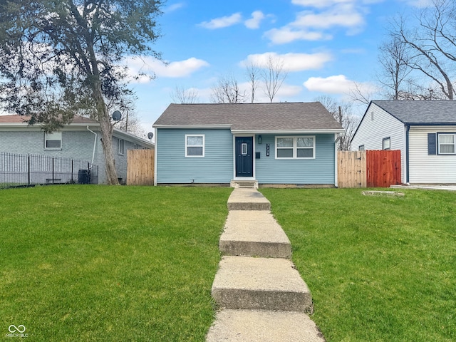 bungalow-style home with a front yard