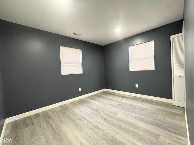 unfurnished room with light hardwood / wood-style flooring