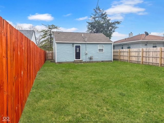 rear view of property featuring a yard