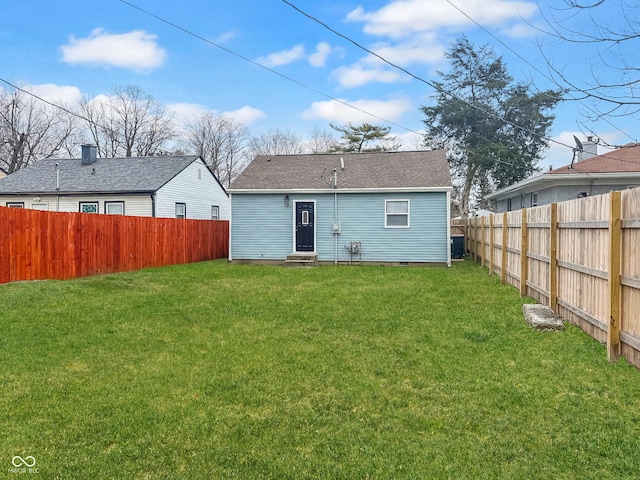 back of house with a yard and central AC