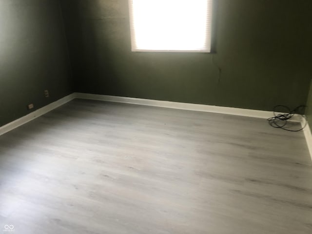 spare room with hardwood / wood-style flooring