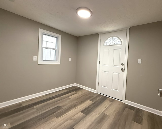 entryway with hardwood / wood-style flooring and a textured ceiling