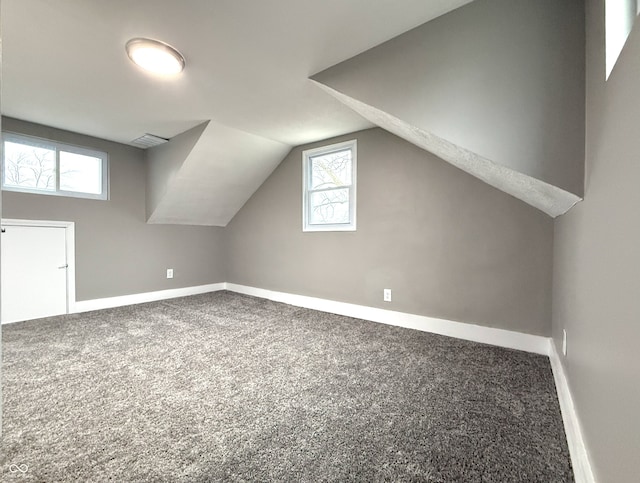 bonus room featuring carpet floors and vaulted ceiling