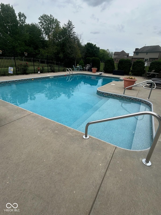 view of pool featuring a patio area and a diving board