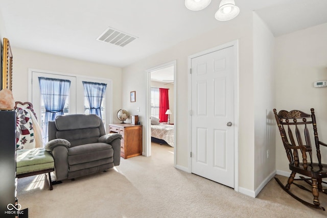 sitting room featuring light carpet