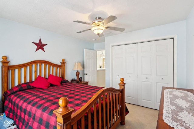 bedroom featuring a closet, light colored carpet, and ceiling fan