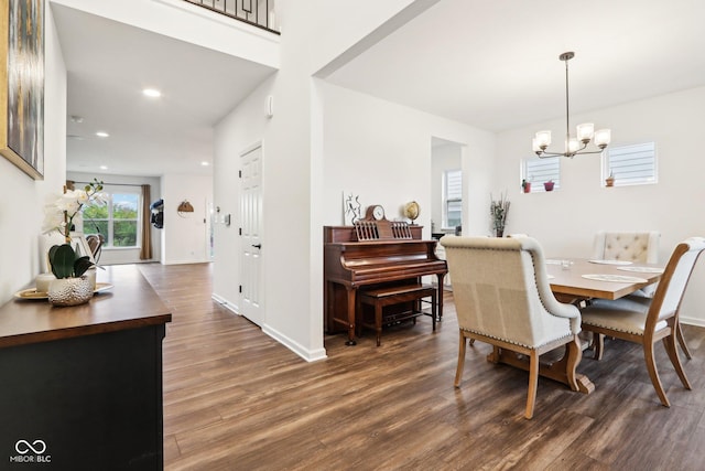 dining area with a chandelier and dark hardwood / wood-style flooring