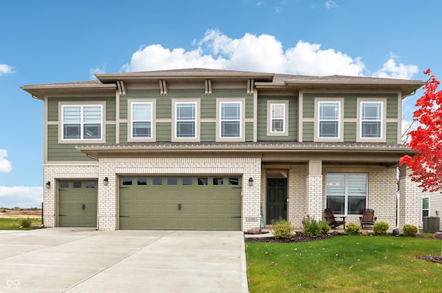 view of front of property featuring a front lawn and a garage