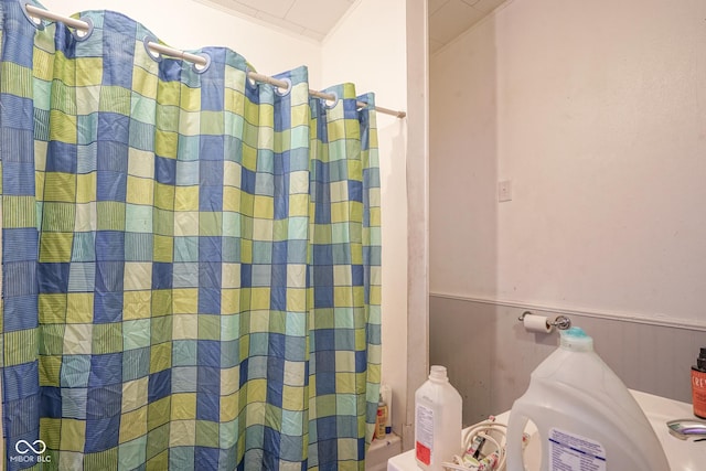 bathroom featuring shower / bathtub combination with curtain and ornamental molding