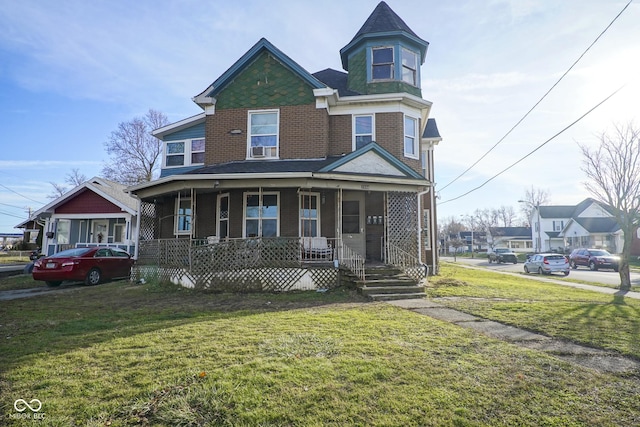 victorian-style house with covered porch and a front yard