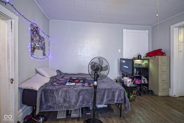 bedroom with wood-type flooring